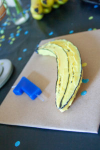 smash cake at banana themed first birthday