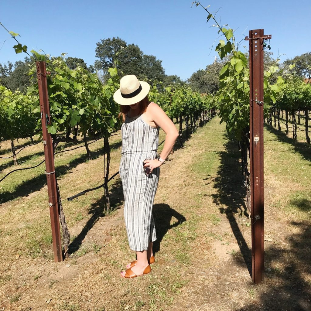 casual linen romper and fedora for wine tasting