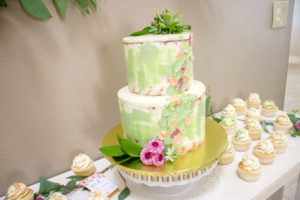 colored naked cake with flower accents