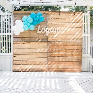 boy baby shower photo backdrop with balloon garland and baby name