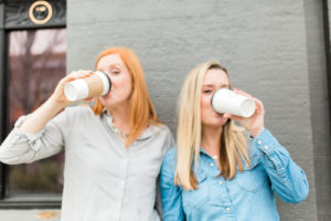 two women drinking coffee