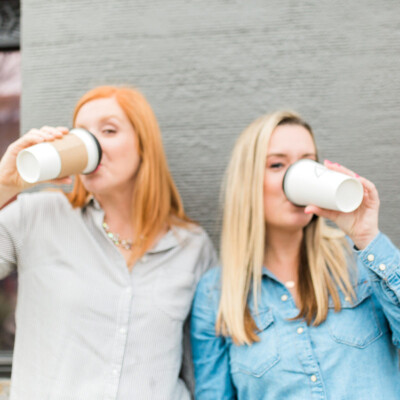 two women drinking coffee