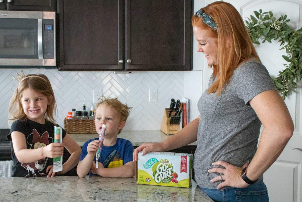 kids and mom enjoying yogurt with box tops for education