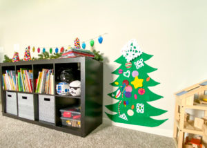 DIY Pom Pom Christmas Trees displayed in playroom