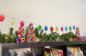 DIY Pom Pom Christmas Trees displayed in playroom