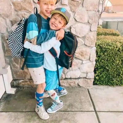 two boys with backpacks on
