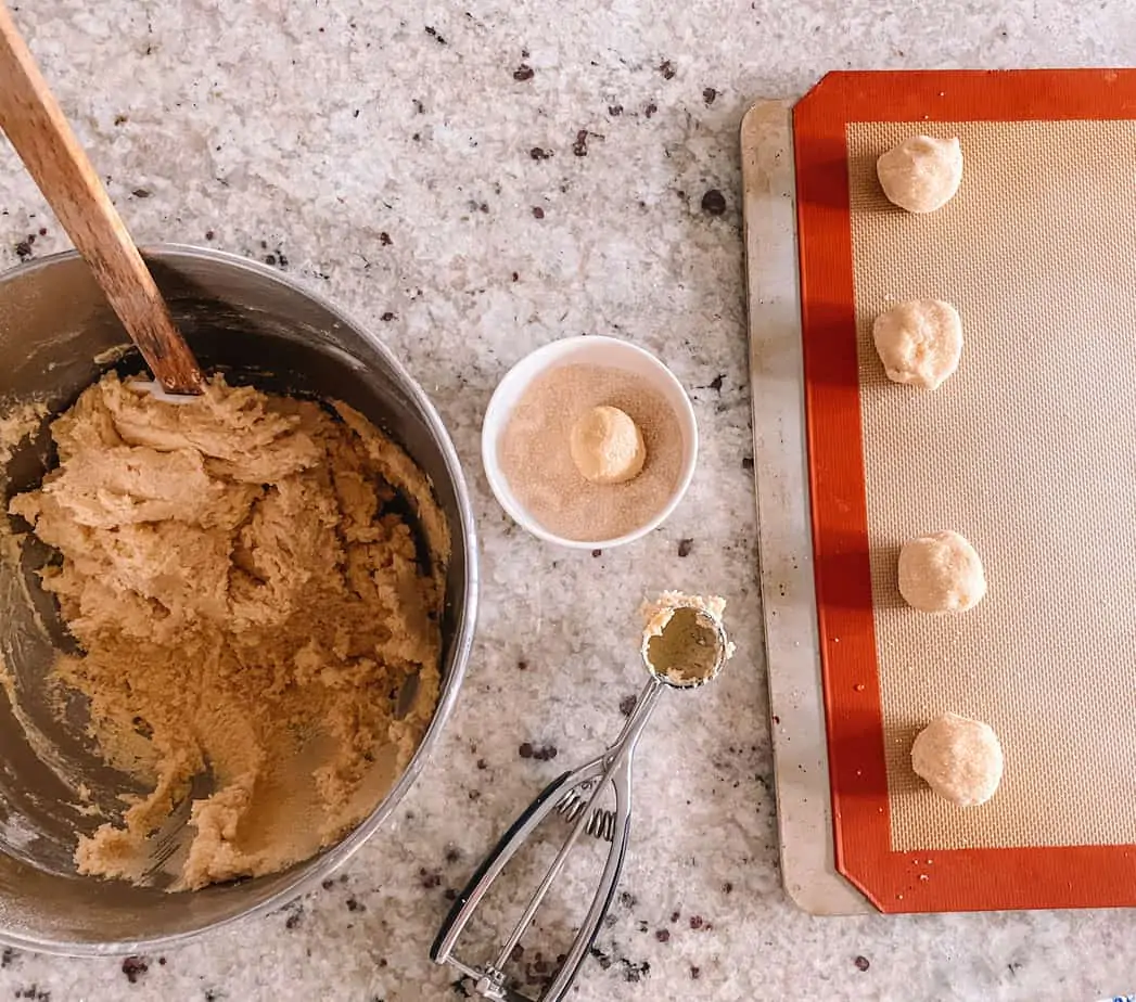Maple sugar cookie dough in a bowl and on a cookie sheet